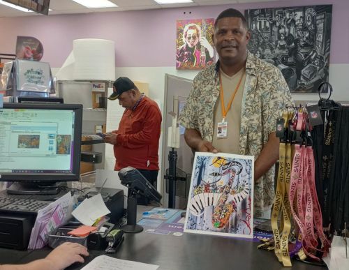 Customer picking up giclée fine art print at local print shop counter — trusted by New Orleans artists for high-quality reproductions
